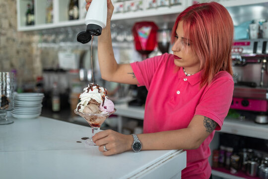 female waitress serving ice cream in an ice cream parlor