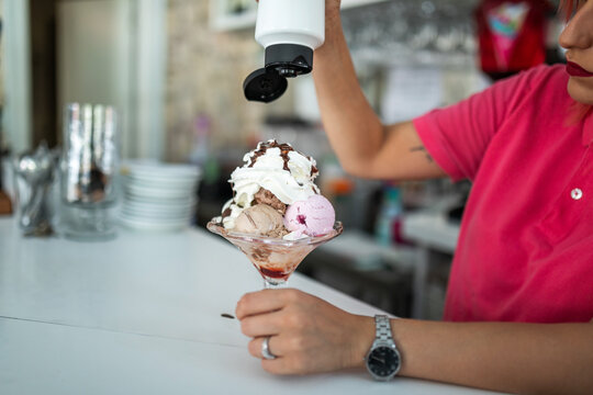 female waitress serving ice cream in an ice cream parlor