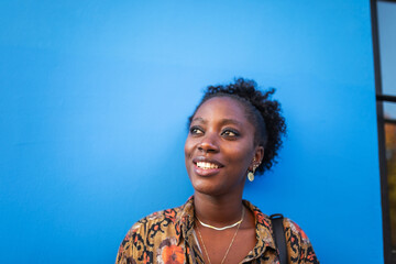portrait of black woman in blue background outdoors