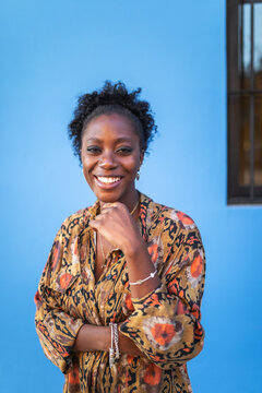 portrait of black woman in blue background outdoors