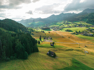 Aerial view of  valley in Swiss Alps surrounded by forest 