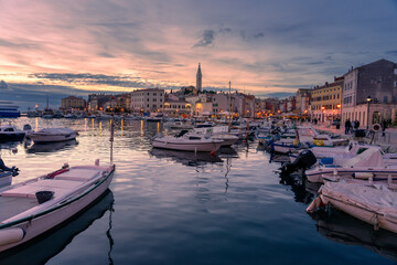 boats in the harbor in Rovinj in the evening with adriatic sea and sunset - obrazy, fototapety, plakaty