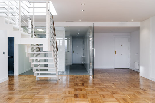 Modern empty duplex apartment living room with stairs to upper floor