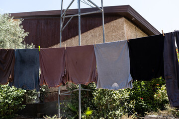 Sunlit Summer Laundry Drying Outdoors on Old Countryside House.