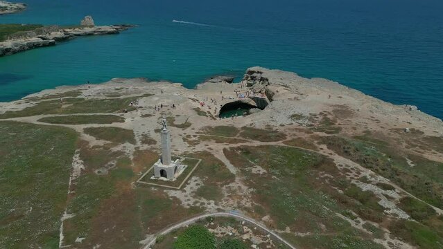 The Grotta della Poesia (aka Cave of Poetry) natural pool, located near Lecce in southeastern Italy, is shown from an aerial, approaching view during the day.