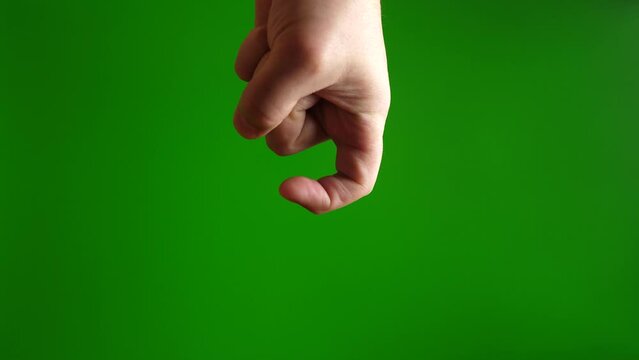 Human hand showing hook gesture with fingers on green background.