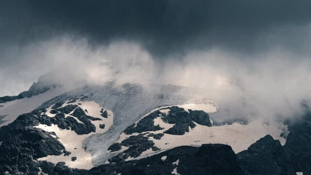 Close-up timelapse of summer storm clouds forming around Piz Ferr&egrave; Glacier