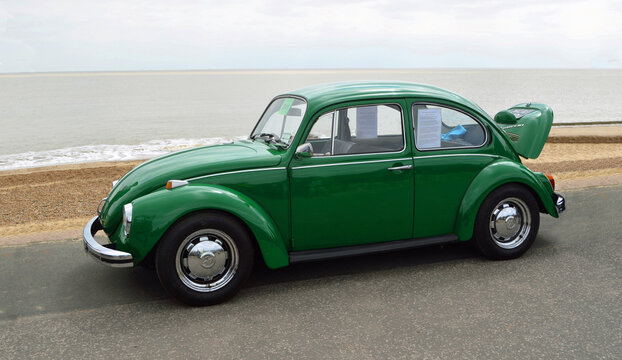 Classic Green  VW Beetle Motor Car Parked on Seafront Promenade.