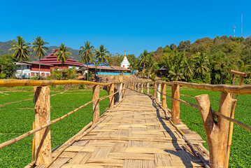 Bamboo bridge over a vegetable field leading to Wat Mok Cham Pae in Mok Cham Pae village, northern Thailand. Most areas of Mae Hong Son province are mountain ranges of the Thai highlands