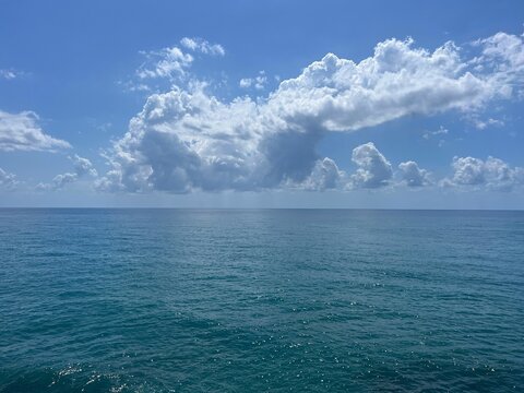 Blue sea, blue sky and scenic clouds.