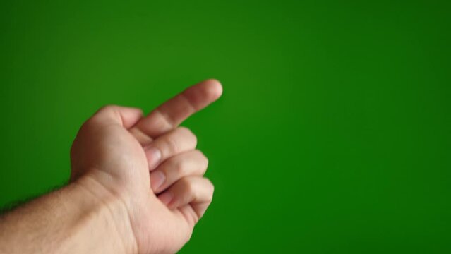Go here finger gesture on green background.