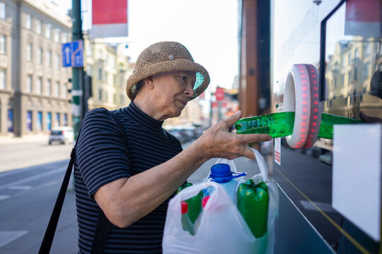 Senior Lady Recycling Plastic Bottles