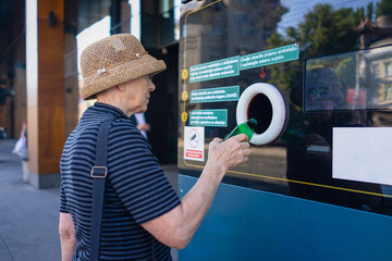Senior Lady Recycling Plastic Bottles