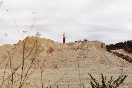 alien standing in an arid lanscape, 35mm