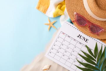 Summer's eve: countdown to sunny days. Top view shot of straw hat, pink sunglasses, June calendar,...