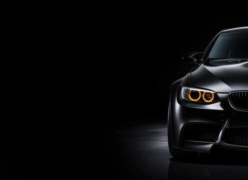 Black generic and unbranded sport car isolated on a black background