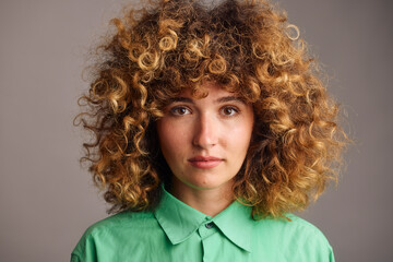 Curly woman in a green shirt