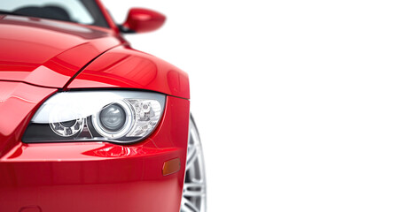Closeup on the headlight of a generic and unbranded red sport car on a white background