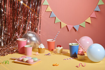 Birthday party table with birthday cake with candles, balloons