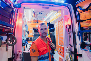 paramedic working on an ambulance at night