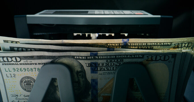 Hundred-dollar bills in the counting machine