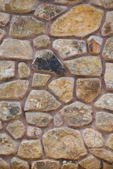 Light brown stone construction.Old stone wall. Building stone walls, garden stone wall historical stone floors. Exterior wall stones.
