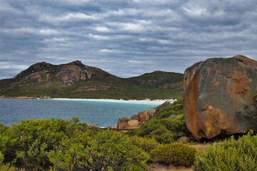 View of Thistle Cove on an overcast day, large granite boulder in the foreground. Cape Le Grand National Park, Esperance, Western Australia 