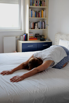 Woman practicing yoga during morning time routine at home