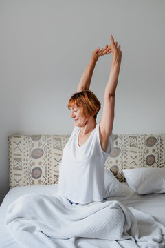 Woman practicing yoga during morning time routine at home