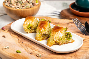 Pistachio şöbiyet baklava. Turkish and Arabic cuisine delicacies. Şöbiyet baklava with clotted...