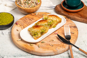 Pistachio şöbiyet baklava. Turkish and Arabic cuisine delicacies. Şöbiyet baklava with clotted...