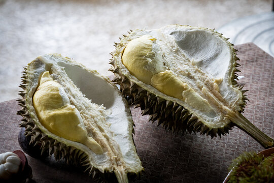 A ripe durian fruit cut in half to eat on table in Pattani, Thailand
