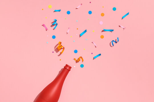Colorful party attributes fly out from botle of champagne wine.