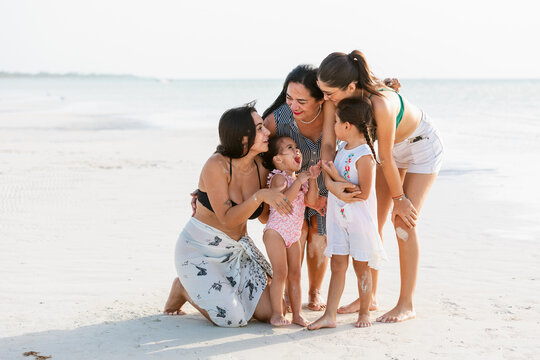 Joyful Women on White Sand Beach