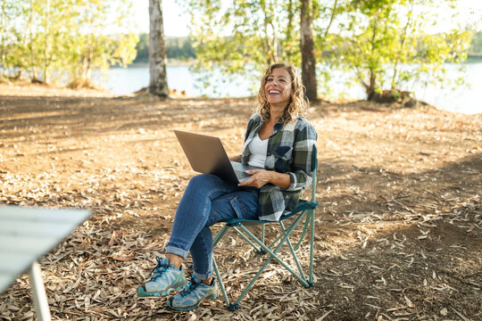 young woman with laptop in nature