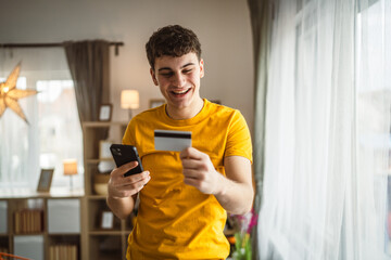 teenager young man at home use credit card shopping online