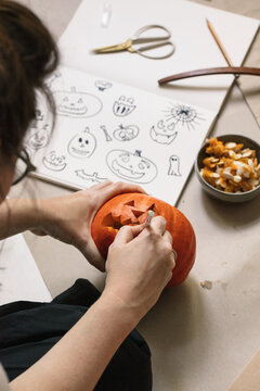 Anonymous Woman Carving Pumpkin Lantern For Halloween
