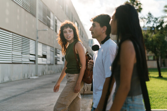 Happy group of students walking on street