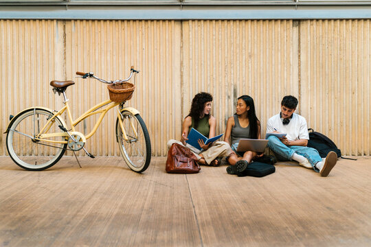 Serious group of students in casual clothes studying together