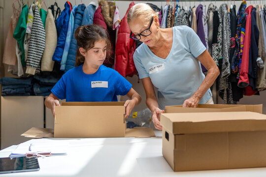 volunteers assembling cardboard gift boxes