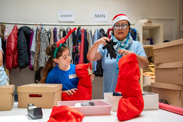 smiled woman and granddaughter volunteering at donations center