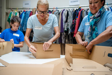 volunteers assembling cardboard gift boxes