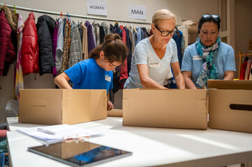 volunteers assembling cardboard gift boxes