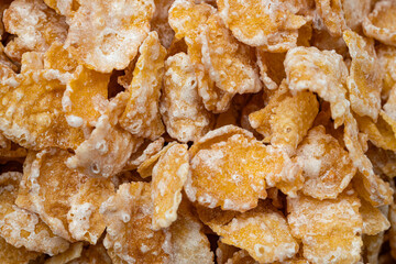 Pile of Sugar-Frosted Flakes of Corn Cereal Scattered Macro Close Up - Ideal for a Quick and Delicious Breakfast