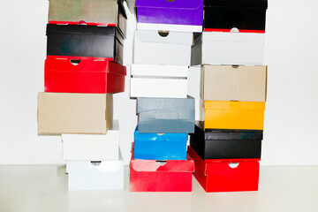 Colourful shoe boxes in towers / stacks with hard direct flashlight