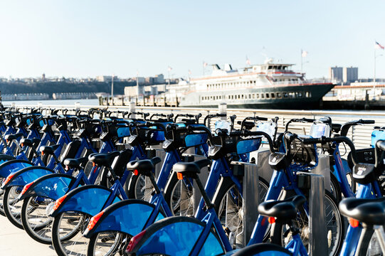 Bicycles on riverside against ship