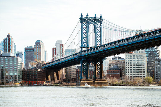 Suspension bridge over river in modern city district