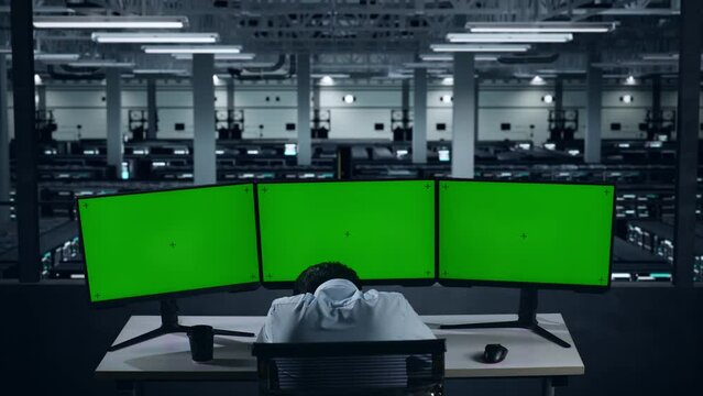 Back View Of Tired Asian Man Sleeping While Working With Mock Up Multiple Computer Monitor In Data Center