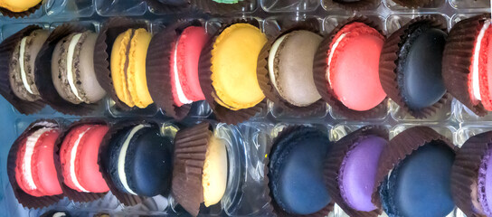 Set of different multi-colored macaroon cookies, a French sweet delicacy. Food background. Close-up.