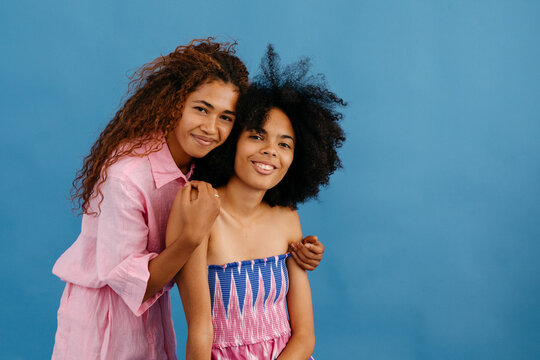 Happy women hugging in studio